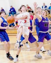 Kanzas Kellum #3 climbs the air in an attempt at a basket. Photos by Fletcher Larsen