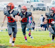 Cowboys Jacob Knox #23 and Jasper Roseberry #21, clear a path for ball carrier Cooper Fay #10.