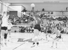 The Warriors go up to protect the oncoming ball by #12 Ava Reagle.