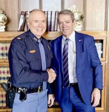 After 38 years in law enforcement, Col. Bolduc, left, will be retiring as the superintendent of the Nebraska State Patrol. Governor Pillen, right, congratulates him on his many years of service to Nebraska.
