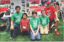 Pictured are from L to R: Luke Osnes, Tyson Osnes (future 4-Her), Tyson Cochran, Ryan Adams and Coach Andrew Utecht at their Team Pit in the UNL Cook Pavilion with their robotics project on display as they wait for competition rounds.