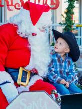 This lil cowboy shares his thoughts with Santa outside Young’s Western Wear Saturday, November 22, 2025 during Valentine’s Holiday Preview. Photo by Tina Boone