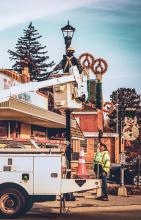 One of the crews putting up Christmas decorations for the upcoming celebration of Jesus’ birth! Stetson Kaufman in the bucket and coworker Dustin Oliver. Photo by Tina Boone