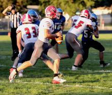 Tristen Beebout #3 looking for a pass as Cinch Miller #33 and Cooper Phillips #65 block the Eagles!