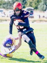 Jacob Knox #23 sneaks away from a Warrior to get the first down.