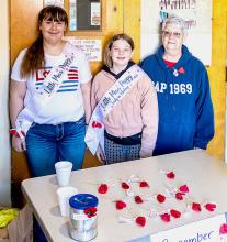 Miss Poppy Ruby Shelbourn, Little Miss Poppy in Waiting Darby Murphy, and President of Leo Brinda Unit 90 Auxiliary Karen Potter.