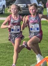 Amelia Wonnenberg and Gunnar Fernau fight to see who can finish first at the Gordon-Rushville Invite. Amelia earned her first medal of season by placing 10th for the middle school girls while Gunnar placed 13th for the middle school boys.