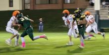 CK senior Kaden McNare #2, junior Wesley Willert #24, and Teagen Fish #3 cannot contain Hay Springs junior Tripp Buettner streaking in the open field in 6-man football action in Hay Springs, NE.