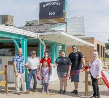 Pictured at Bulldogers BBQ’s Ribbon Cutting are from L to R: Dean Jacobs, Jason Kelber, Lauralee and Ann Kruger, Courtney Bristol, Heath Bristol, and Nadeane Allard. Photo by Laura Vroman