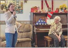 Ella Brennemann shares her Bronze Medal speech she wrote for the American Legion Oratorical Contest. Yvonne Hollenbeck, at right, played piano for the patriotic songs that were enjoyed at Cherry Hills.