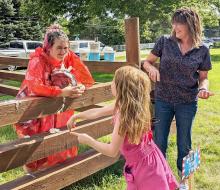Lilybet Rolfe is being pied in the face at their very short Carnival to raise funds for an Ecology Park swing.