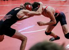 Deklin Titus ties up with his McCook opponent and gets the win and placed third at the Valentine Invitational.
