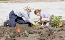 Volunteers Amy Arganbright and daughter Juliette, worked in the middle portion of town adding plants to the various bumpouts located there. Amy was hopeful that plants would be inspirational to the community. Photos by Laura Vroman