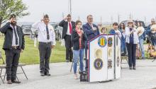 Pictured are from L to R: Monty Krueger, Rex Gallino, Don Nelsen, JoJo Jordan, Pastor Scott McClellen, Little Miss Poppy in Waiting Darby Murphy, Little Miss Poppy Ruby Shelbourn, Ginny Nelsen, Kitty and Rick VanderWey.