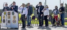 Pictured are from L to R: Pastor Paul Maunu, Tim Witte, Titus Maunu singing the National Anthem, Rex Gallino, Tim Wilkinson, Don Nelsen, Ginny Nelsen, Kitty Vander Wey, and Rick Vander Wey. Photos by Laura Vroman