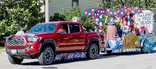 Pictured above is the Roth Family float, and below is the Valentine Swim Team, both winners in the Liberty Fireworks sponsored parade. Photos by Laura Vroman
