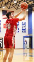 Caden Stankoski #10 up for 3 pointer.