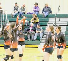 Cowgirls celebrating after a long rally against the Warriors. Photos by Shontell Roseberry