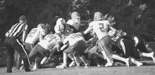 The ref has a keen eye on who has the ball in this Badger\Crofton pile. Photos by DeanNa Fowler