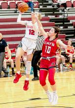 Tacey From #12 is being defended heavily by her opponent in the Holiday Tournament. Photos by Fletcher Larsen
