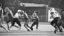 Bryan Keller #22 backs away from the line of scrimmage, looking for a hole to gain yardage, Friday, September 10. Photos by DeanNa Fowler