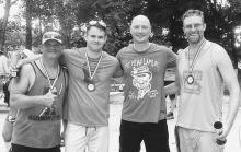 Pictured are from L to R: Tommy Broom, Mike Huggins who placed second in the men's solo unlimited, race organizer Joe Mann, and Josh Krueger who placed third in the men's kayak class 18' or less category. Congratulations!