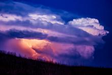 Skipping along the Sandhills, lightning illuminates this giant cloud as the winds buffet the grasses. Thankfully, this storm was a quiet one, without tornado activity, or grass fires in 2024. Photo by Laura Vroman