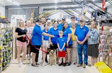 Pictured at the Tooth and Whisker Outdoors Ribbon Cutting are back row, L to R: Susan Stec, Jeremy Stec, Diana Ostrander, Josh Purdy, and Mike Burge. Front row, L to R: Jennifer Moore, Brayden Stec, Tyler Brown, Elise Brown, Andrea Brown, Weston Brown, Dawn Shelbourn, Angie Brown, Greg Brown, and Deanne Holmes Monroe. Photo by Laura Vroman