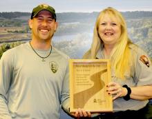 Travis Connot is being presented the River Management Society Resource Manager of the Year plaque by Niobrara National Scenic River Superintendent Susan Cook.