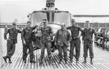 Pictured from L to R: SP5 Tom Franks, flight medic; SP5 Dave Farnum, crew chief; unidentified Marine reporter bodyguard; Gunter Stiller, Chief Reporter for Bild am Sonntag newspaper; Captain Robert Robeson, aircraft commander; and CW2 Tim Yost, now deceased copilot, at Red Beach heliport after flight to evacuate captured and seriously wounded NVA officer. Photo by Gunter Stiller