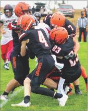 A posse of Cowboys in on a tackle against the Indians. Photo by Shontell Roseberry