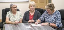 Pictured are Louise Heinert, Carolyn Moore, and Kim Marlatt signing the paperwork to allow the Sandhills Area Foundation to be a conduit for tax free donations to the Sparks Church to help with its refurbishment. Photos by Laura Vroman