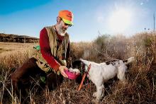 Nenneman gives Patch a drink. Especially while covering large expanses, a hunter must tend to the dog’s needs. Photo by Justin Haag, Nebraskaland Magazine