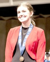 Finley with her third place medal at NSAA Speech Championships. Photo by Chris Mosner