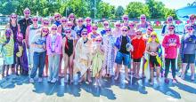 Swimmers gather together after competition for medals, smiles, and coolest tropical pink shades!