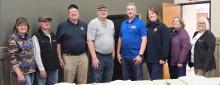 Rotarians are pictured from L to R: Ann Neiffer, Monty Neiffer, Steve Isom, Bruce Johnson, Dick Cochran of Hot Meals USA, Regina Osburn, Sherri Britton, and Nadeane Allard.