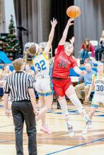 Kinsey Buechle grapples for control of the ball at the tip-off. Photos by Fletcher Larsen