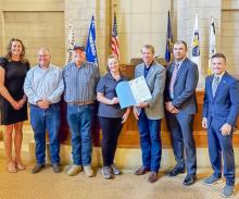 Wendy Murphy, center with Governor Pillen after signing a proclamation designating August as National Shooting Sports Month in Nebraska.