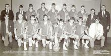 Pictured are the 1970 Class B State Tournament Badger Basketball Team. Back row, L to R: Coach Del Schoenfish, Steve Riley, Tom Elliott, Blaine Harris, John Miller, Bob Perrett, Tom Mulligan, Tom Randall, Ron Clingenpeel, Head Coach Cliff Jacobs. Front row, L to R: Mike Dill, Joe Holmes, Jim Fischer, Larry Shaw, Craig Beman, Larry Todd, Bill Howell, and George Johnson. The photo was taken before 49-46 win over Sydney with a final record 20-4. Rangeland, Nebkota, District Champs.