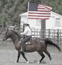 Meghan Peterson rides into the arena at the introduction of the Circle C Rodeo. Photo by Joslyn Nollette