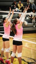 Tylee Tinant and Clarrah Beebout blocking against the Cowgirls.