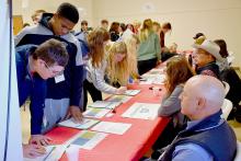 Students line up at the Transportation booth where they find out what type of vehicle they have and how best to budget for it. Photos by Makenzie Ward