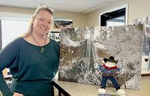 Here Regina of the Cherry County Visitors Center shows Flat Stanley a photo of Smith Falls. The stairway was under construction, so they were unable to visit...but you can visit it NOW. Photos by Carolyn Semin