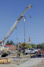 IES prepares a giant drill that will hold Valentine’s new traffic signals. Photo by Laura Vroman