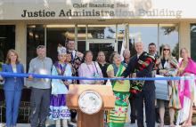 Gov. Ricketts (fourth from right), First Lady Susanne Shore (far left), members of the Ponca tribe, State leaders, and muralist Sarah Harris (second from right) at the dedication ceremony.