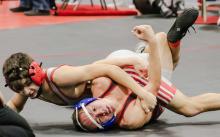 Rownan Eggert is working to keep his opponent down on the mat. Photos by Karen Phillips