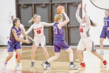 Malika Monroe #30 guards the Minden player, while Kaetryn Bancroft #10 assists. Photos by Fletcher Larsen