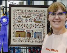 Janell Stoeger’s cross stitch project received first place at the Nebraska State Fair in Best in County category. She stitched Teresa Kogut’s Land That I Love pattern on 40 count (20 stitches per inch) linen and called for flosses.