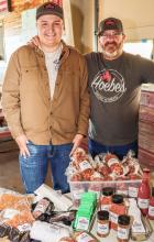 Blake and Jason Hoebelheinrich with some of Hoebe’s Smoke ‘N’ Meats products Photo by Tina Boone