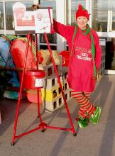 Pat Battershaw dressed in her elfin best to ring the Salvation Army Bell in front of Bomgaars. Check out her velvet shoes!
